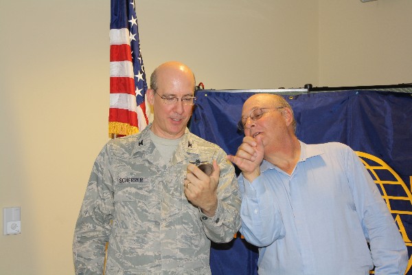 Mitch Abel (r), chapter president, presents Col. Scherrer with a chapter coin follow his speech at the July meeting.